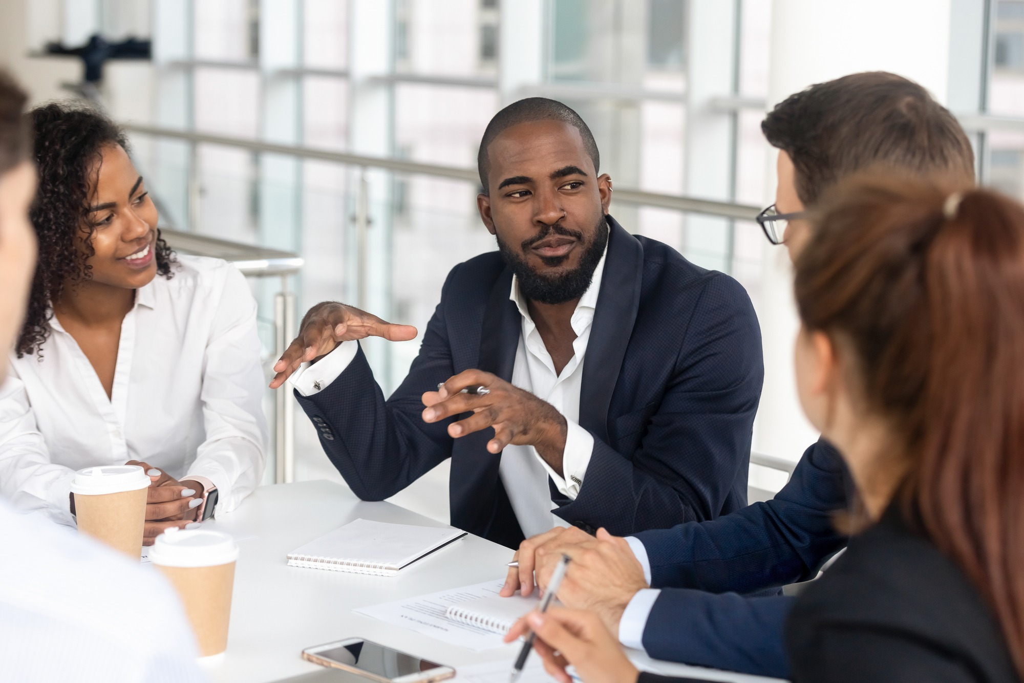 Millennial employees gathered in boardroom for training